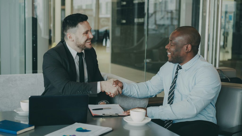 Two business professionals shaking hands - representing the trusted consulting partnership Loughmore builds with Australian SMEs